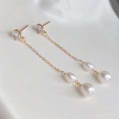 * DETAILS * This listing is a pair of earrings only.  - Freshwater Pearl - 14K Gold Plated CZ Post Earrings  - 14K Gold Plated Chain 👉🏻For more earrings, see https://www.etsy.com/shop/JinnysJewelryBySeJin ✨matching earrings. https://www.etsy.com/JinnysJewelryBySeJin/listing/1259483823/freshwater-pearl-earrings-bridal?utm_source=Copy&utm_medium=ListingManager&utm_campaign=Share&utm_term=so.lmsm&share_time=1656461065010 👉🏻You may also like matching necklace. https://jinnysjewelrybysejin.etsy.c Delicate Gold-plated Earrings For Formal Occasions, Delicate Gold Plated Earrings For Formal Occasions, Elegant Yellow Gold Crystal Earrings For Anniversary, Elegant 14k Gold Pearl Earrings For Wedding, 14k Gold Linear Earrings For Wedding, Gold Long Drop Bridal Earrings, 14k Gold Dangle Bridal Earrings As Gift, 14k Gold Round Linear Earrings For Wedding, Gold Long Drop Bridal Earrings For Formal Occasion