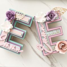 the letters e and f are decorated with paper flowers