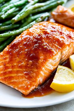 salmon, asparagus and lemon slices on a white plate