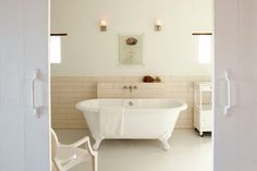 a white bath tub sitting inside of a bathroom