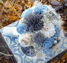 a blue and white bouquet sitting on top of a table