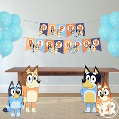 three cartoon dogs are standing in front of a table with blue balloons and happy birthday banner