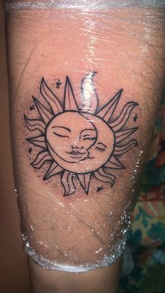 a sun and moon tattoo on the leg