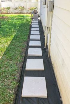 a long row of stepping stones in front of a house