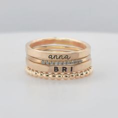 This stylish Layla Set features two 14K yellow gold filled name rings, a 10 mini cubic zirconia ring, and a beaded ring. As a layering set, two kids' rings make this the perfect everyday jewelry that offers subtle, yet memorable, sparkle.  Includes one name in lowercase cursive and one name in uppercase bold. Please note that this set is handmade and can involve color variations due to soldering and engraving. Ring sizers are highly recommended and are available here:  https://www.etsy.com/listing/239177790/adjustable-ring-sizer-ring-sizing-gauge?click_key=71e876eeee696b998f8247d60178e130107ab1c1%3A239177790&click_sum=8b17579e&ref=shop_home_active_7&frs=1&crt=1 and more sizing info can be found in our FAQs: https://www.etsy.com/shop/ShopGoingGolden/policy Personalized Dainty Gold Engraved Ring, 14k Gold Stackable Rings With Custom Name For Anniversary, Custom Name Stackable Rings In 14k Gold For Anniversary, Custom Name 14k Gold Stackable Rings For Anniversary, Adjustable Stackable Engraved Ring For Anniversary, Adjustable Engraved Text Ring, Engraved Rose Gold Rings For Personalized Gift, Personalized Rose Gold Engraved Ring, Customizable Stackable Rose Gold Rings