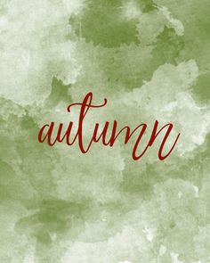 the word autumn written in red ink on a green watercolor textured paper background