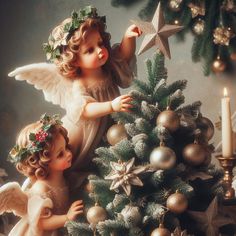 two angel figurines are decorating a christmas tree