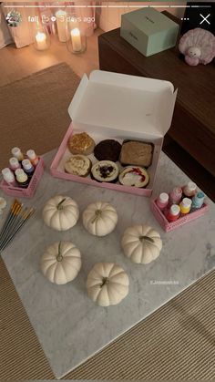 a table topped with lots of donuts and cupcakes