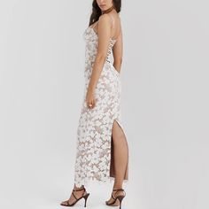 Elevate your wardrobe with this captivating bodycon maxi dress, perfect for making a lasting impression. The dress features delicate white lace-up details and exquisite floral embroidery, blending modernity with romantic elements. Spaghetti straps lend an airy and sophisticated look, while the back split provides both style and practicality. Whether attending a wedding, an upscale dinner, or a fashionable gathering, this dress ensures you’ll stand out in refined elegance. Color: WhiteNeckline: S Elegant Summer Lace Dress With Floral Embroidery, Maxi Lace Dress With Floral Embroidery, Delicate Fitted Sleeveless Dress, Maxi Length Lace Dress With Floral Embroidery, Evening Backless Dress With Delicate Lace, Elegant Floral Embroidery Lace Dress For Summer, Delicate Fitted Evening Dress, Delicate White Dresses For Spring, Delicate Evening Dress