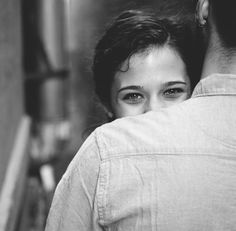 black and white photograph of a man hugging a woman's back in an elevator