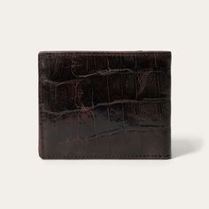 Made from top-grain leather, this bi-fold wallet features a brown embossed croco print and a tooled brown leather western overlay with an embossed Stetson logo. At once rugged and refined, each of our wallets embodies our legendary commitment to quality and attention to detail. 4.5" x 3.5" (115mm x 90mm) Leather Imported Luxury Brown Trifold Wallet With Coin Pocket, Classic Embossed Wallets For Formal Occasions, Classic Embossed Leather Wallet, Formal Bifold Wallet With Embossed Details, Leather Bifold Wallet With Crocodile Pattern, Brown Embossed Leather Wallet, Classic Embossed Bifold Wallets, Brown Textured Leather Bifold Wallet, Formal Brown Wallet With Crocodile Pattern