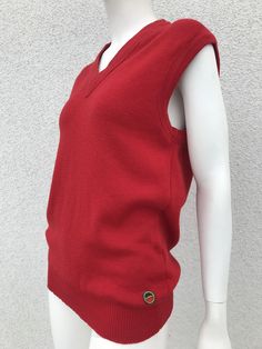 "A warm, stylish and cute waistcoat all in one. The vest is bright red, V-neck, very stretchy and well loved and maintained. A beautiful and perfect gift for yourself or your loved one. Material: 100 % wool. Size: the label does not specify the size and it is best suited for wearers EU 36/38, UK 8/10, S-Small/M - Medium. Please also check the measurements at the bottom: MEASUREMENTS: Shoulder: 16.14 inch / 41 cm Armpit to Armpit: 17.91 inches / 45.5 cm Waist: 17.32 inch / 44 cm Length: 27.36\" / 69.5 cm CONDITION: in very good vintage condition.  All measurements are taken when the garment is flat. Due to lighting, color of product may slightly vary compared to photos. Follow our store for new exclusive vintage clothing just for YOU! SHIPPING * I ship worldwide via Priority mail (Lietuvos Knit Vest Outfit, Fall Vest, Red Knit Sweater, Knit Sweater Vest, Red Vest, Wool Vest, Casual Vest, Vest Outfits, Street Outfit