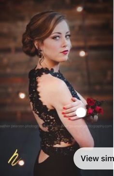 a woman in a black dress holding a red rose