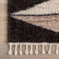 an area rug with various colors and fringes