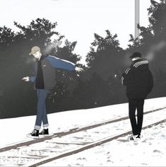 two people are walking in the snow with their arms out and one person is holding an umbrella