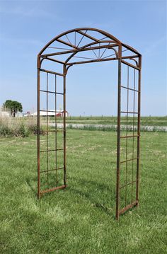 a metal structure sitting on top of a lush green field