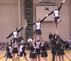 a group of cheerleaders standing on top of each other