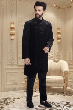 This black sherwani is adorned with delicate cutdana and shimmering sequins, making it an exquisite choice for sangeet ceremonies or reception nights. The perfect choice for any wedding, this sophisticated piece will have you looking and feeling your best. Bollywood Style Wedding Sherwani For Winter, Bollywood Style Sherwani For Wedding In Winter, Bollywood Style Sherwani For Winter Weddings, Winter Wedding Bollywood Bandhgala, Bollywood Style Bandhgala For Winter Wedding, Elegant Sherwani With Dupatta For Reception, Elegant Bandhgala With Dupatta For Reception, Formal Black Kurta With Dabka Work, Elegant Nehru Jacket With Dupatta For Reception