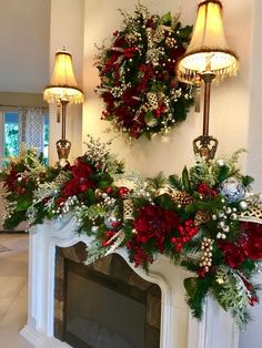 a fireplace decorated for christmas with wreaths and lights