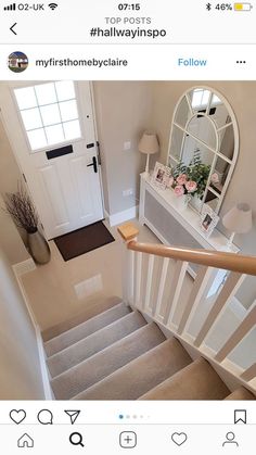 the stairs in this house are decorated with white and beige decor, along with a mirror