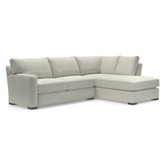 a white sectional couch sitting on top of a white floor