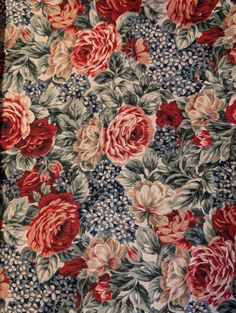 an old flowered fabric with red and white flowers on it's blue background