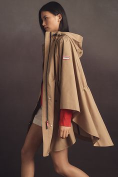 Don't forget a jacket – the season's staple is having a moment. Make a statement in this rain-bonded novelty cape from Hunter, featuring seam-sealed waterproof construction, an adjustable hood and waistband, and welt pockets. | Rain Bonded Novelty Cape Jacket by Hunter in Beige, Women's, Size: Large/XL, Polyester at Anthropologie Hooded Jacket Pattern Sewing, Hooded Jacket Pattern, Rain Cape, Cape Pattern, Dress Up Boxes, Jacket Pattern Sewing, Cape Jacket, Raincoats For Women, The Hunter