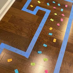 the floor is covered with colored post it notes and tape to make an interesting maze