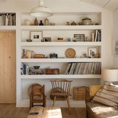 a living room filled with furniture and bookshelves