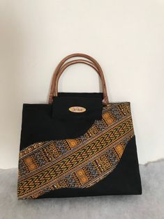 African Kente Handbag/Purse. Elegant and stylish. African Fabric/Multi Colored Bag with bamboo/cane handles.  Handles may vary and subject to availability. Handles may come in bamboo, clear or any other color. Pattern on fabric may also vary  Size is approximately 16.5 (L) x 11 inches (H) X 3.5 (W) Multi Colored Bag, Vanity Bag, Handmade African, Top Handle Bags, Black Purse, Handbag Black