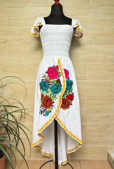 This beautiful dress is the perfect style to attend a Mexican party, with beautiful floral embroidery, has a spring at the waist to adjust the figure and a ducktail design. This dress is one size and fits S/M. Handcrafted machine embroidered dress. Each dress has unique embroidery so colors may vary. We ship anywhere in the word, from Tepic, Nayarit,  mx. Made by artisans from Oaxaca, Mx We recommend washing by hand with cold water, tender in the shade, to better preserve the original color. Floral Print Dress With Asymmetrical Hem For Garden Party, Embroidered Midi Dress For Garden Party, Midi-length Embroidered Dress For Garden Party, Garden Party Midi Dress With Embroidered Hem, Garden Party Midi-length Embroidered Dress, Asymmetrical Hem Maxi Dress For Garden Party, Fitted Maxi Dress With Asymmetrical Hem For Garden Party, Summer Floral Print Dress With Asymmetrical Hem, Fitted Sleeveless Maxi Dress With Floral Embroidery