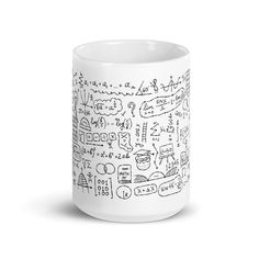 a white coffee mug filled with lots of doodles on the inside of it's cup