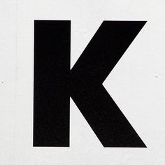 the letter k is black and white with an arrow on it's left side