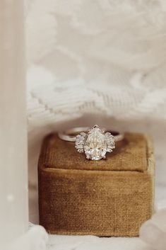 an engagement ring sitting on top of a box