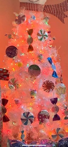 a white christmas tree decorated with lollipops and candy