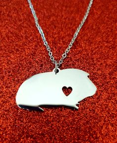 This beautiful guinea pig necklace is the perfect gift! Purchase it for yourself, a friend, a family member, or a partner. If you know someone who loves guinea pigs, this is a must have.   Details: -10 in chain length -The guinea pig pendant is 10 in wide and 1 in tall -Made of stainless steel -Comes in a fastened black velvet pouch as seen in the photo. *Please note that this is not handmade by me. **Please check out my other listings for additional small pet jewelry Pig Necklace, Pet Jewelry, Necklace With Heart, Small Pet, Velvet Pouch, Gift For Kids, Guinea Pig, Animal Jewelry, Guinea Pigs