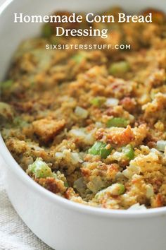 a casserole dish with stuffing and vegetables in it on a white cloth next to a fork