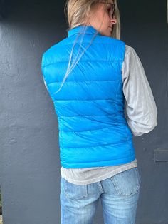 Stay toasty and on trend with the Beacon 2 Vest! This ultra-cozy puff vest has a high-neck design and a storage pouch for all your essentials. Keep warm and snug whether you’re out and about or just lounging around. Feeling fly has never been so easy! Sleeveless Blue Outerwear For Outdoor Activities, Casual Cold Weather Vest With Pockets, Casual Solid Vest For Cold Weather, Casual Nylon Vest For Cold Weather, Casual Nylon Vest For Winter, Blue Vest For Outdoor Winter Activities, Winter Functional Solid Vest, Functional Solid Color Winter Vest, Functional Vest For Outdoor Activities In Fall