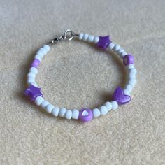 - One Of A Kind Beaded Charm Bracelet - Featuring Purple And White Seed Beads And Shaped Beads - Silver Colored Hardware - Clasps Closed. No Stretch. - Size/ Circumference Is 6.5” - Handmade (By Myself). Perfect To Treat Yourself Or To Give As A Unique Gift! **Add 2 Jewelry Items Marked “2 For $20” To Your Bundle And I Will Send You An Offer For $20** Check Out The “Boutique” Tab In My Closet For Handmade Earrings, Bracelets, And Necklaces! Indie Bracelets, Tiny Bead Bracelet, Purple Beaded Bracelets, Jewelry Stacking, Beaded Charm Bracelet, Hearts And Stars, Crystal Bead Jewelry, Wrist Stacks, Clay Bracelet