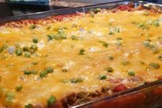 a casserole dish with cheese and green onions