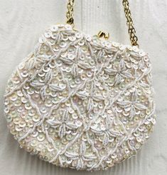 🎀  Gorgeous Vintage Embellished Bag  🎀 HAND MADE IN HONG KONG unbranded embellished with sequins and beads front and back 1 interior slip pocket kisslock closure adjustable gold chain strap to be tucked in or set at 2 different lengths excellent vintage condition 7 in width 5.5 in height 0.5 in depth Embellished Bags, White Beads, Gold Leather, Ivory White, Chain Strap, Cross Body Handbags, Purses And Handbags, Gold Chains, Hong Kong