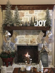 a living room with a fireplace decorated for christmas