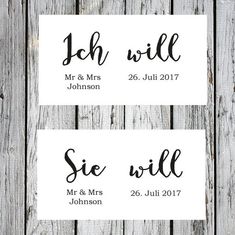 two wedding stickers with the names of each bride and groom, on wooden background