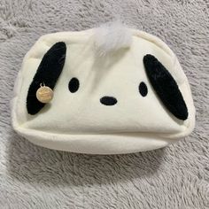 a white and black stuffed animal hat with ears