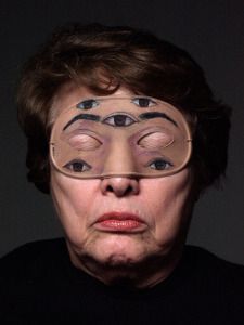 an older woman wearing glasses with her eyes covered in fake eyebrows and eyeliners