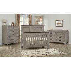 a baby crib with drawers and dressers