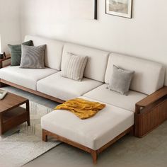 a living room with a white couch and wooden coffee table