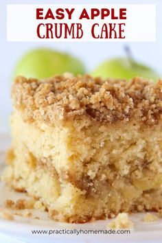 a close up of a piece of cake on a plate with two green apples in the background