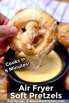 an air fryer pretzel being dipped with butter