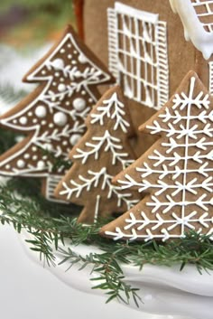 gingerbread cookies decorated with white icing and snowflakes are on a plate